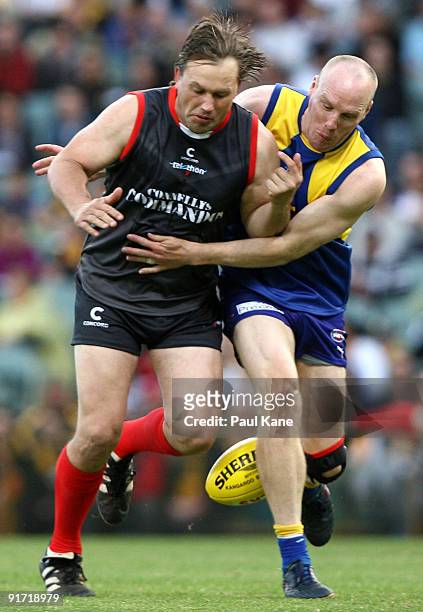 Ashley McIntosh tackles Tony Modra during the Chris Mainwaring charity AFL match at Subiaco Oval on October 10, 2009 in Perth, Australia.