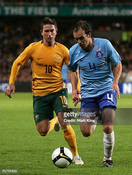 Joris Mathijsen of the Netherlands controls the ball in front of Harry Kewell of the Socceroos during the International friendly football match...