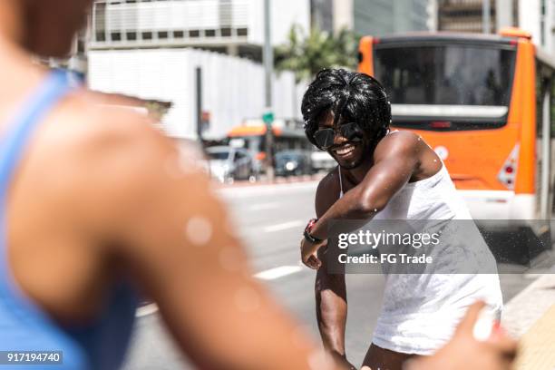 young friends having carnival party at the street - rio de janeiro celebrates during carnival season stock pictures, royalty-free photos & images