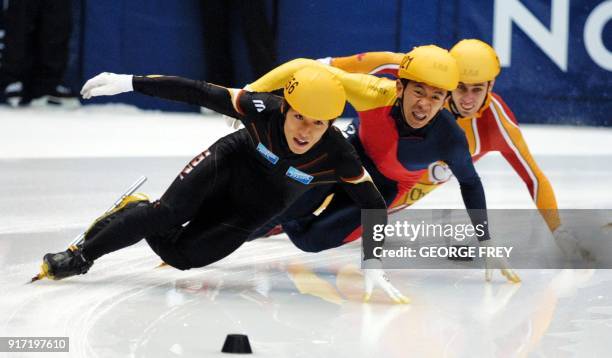 Takafumi Nishitani from Japan leads the pack as JiaJun Li from China and Eric Bedard from Canada give chase during the finals of the Men's 500m at...