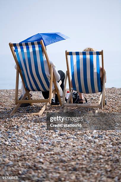 two deckchairs on the brighton beach - brighton deckchair stock pictures, royalty-free photos & images