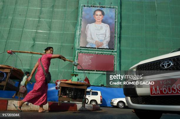 Huge portrait of Myanmar's de facto leader Aung San Suu Kyi is displayed on a building construction site overlooking Mahabandoola park in Yangon on...