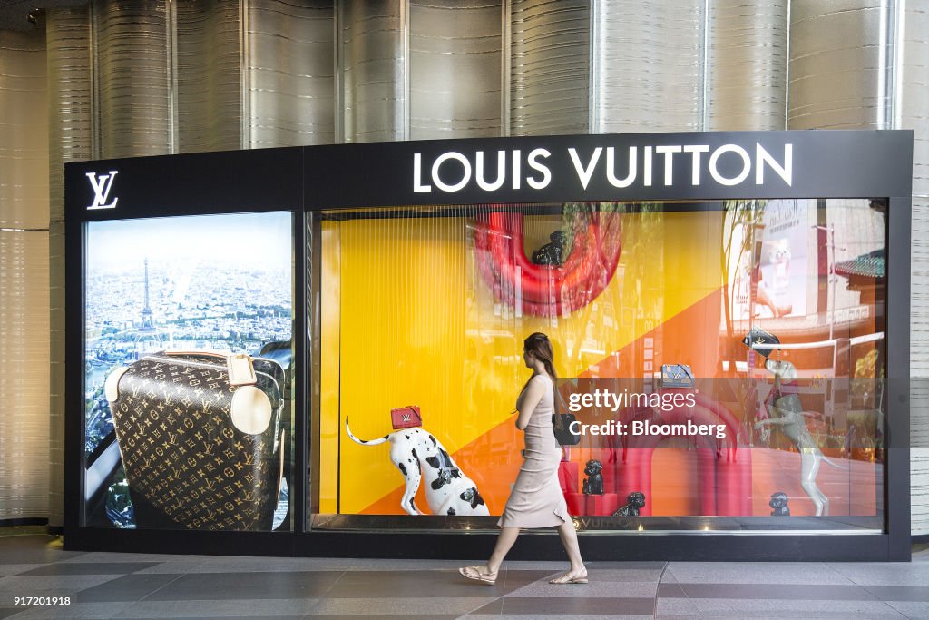 A pedestrian walks past the window display of a Louis Vuitton store,  News Photo - Getty Images