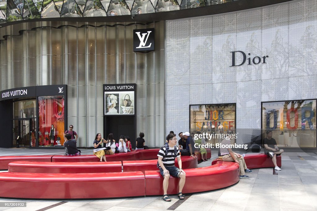 People sit outside a Louis Vuitton store, operated by LVMH Moet News  Photo - Getty Images