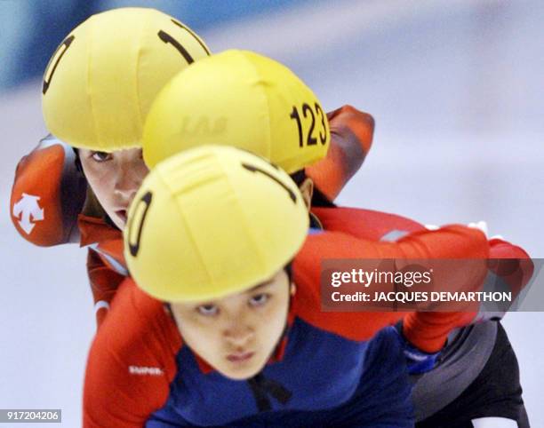 Christy Ren of Hong Kong skates ahead of Chinese Yang Yang and Canadian Marie-Eve Drolet during the women's 1000m heats of the short track speed...