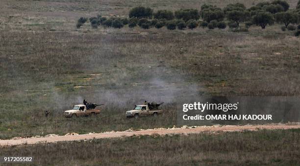 Picture taken on February 10 from the Syrian village of Atme in the northwestern province of Idlib, shows Syrian rebel fighters allied with Turkey...