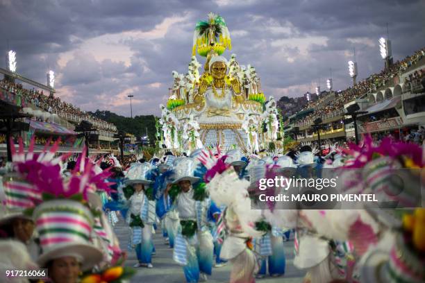 Revellers of the Mocidade samba school perform as the sun rises after during the first night of Rio's Carnival at the Sambadrome in Rio, Brazil, on...