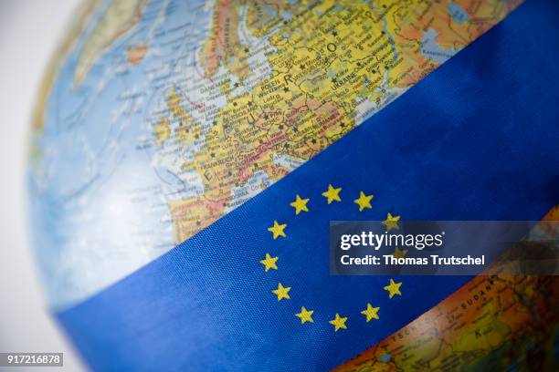 Berlin, Germany A ribbon with the logo of the European Union is bound around a globe on February 08, 2018 in Berlin, Germany.