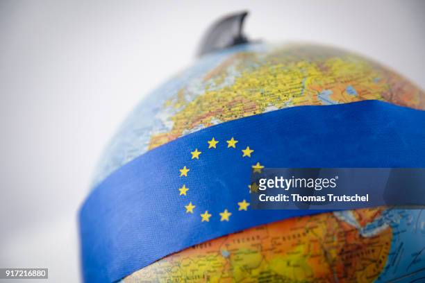 Berlin, Germany A ribbon with the logo of the European Union is bound around a globe on February 08, 2018 in Berlin, Germany.