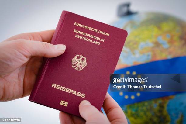 Berlin, Germany A German passport is held in front of a globe on February 08, 2018 in Berlin, Germany.