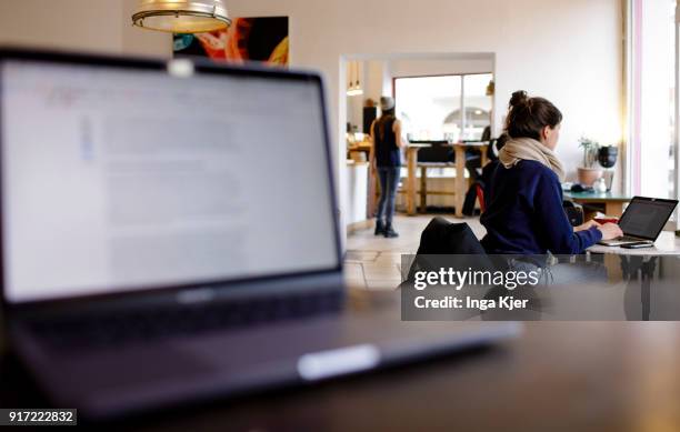 Young woman works on her laptop in a cafe, on February 09, 2018 in Berlin, Germany.