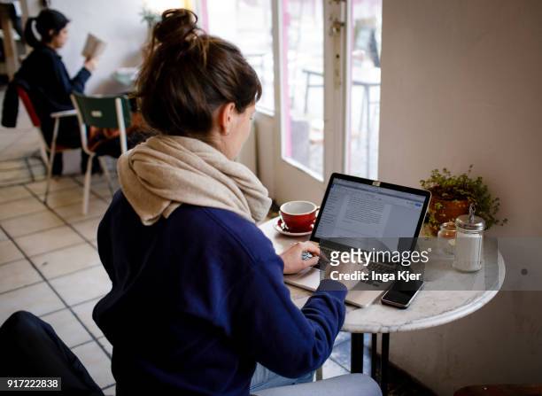 Young woman works on her laptop in a cafe, on February 09, 2018 in Berlin, Germany.