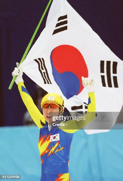 Chun Lee-Kyung of South Korea carries the Korean flag as she skates a lap of honour around the White Ring rink in Nagano after winning the gold medal...