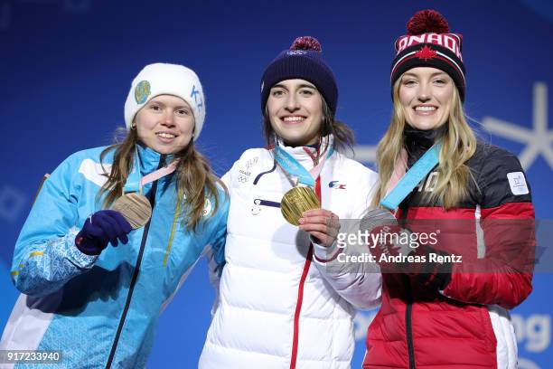 Bronze medalist Yulia Galysheva of Kazakhstan, gold medalist Perrine Laffont of France and Silver medalist Justine Dufour-Lapointe of Canada pose...