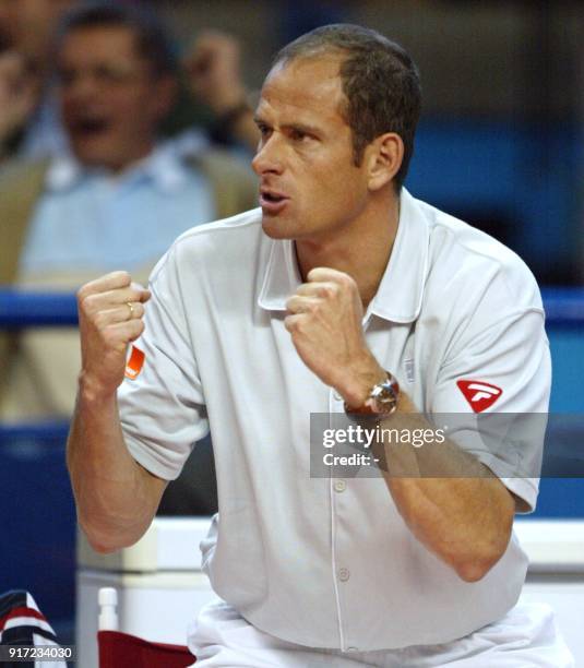 Le capitaine français Guy Forget encourage Sébastien Grosjean, le 07 avril 2002 au palais des sports de Pau, au cours de son match contre le Tchèque...