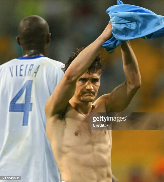 Bixente Lizarazu of France acknowledges the fans as Patrick Vieira walks off, 06 June 2002 at the Busan Asiad Main Stadium in Busan, following the...