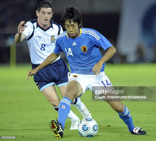 Japan's midfielder Kengo Nakamura keeps the ball before Scotland's midfielder Graham Dorrans during their Kirin Challenge Cup football tournament in...