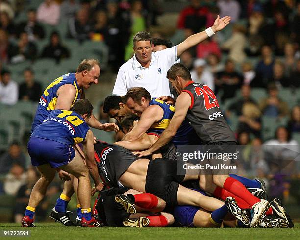 An umpire awards a free kick as a melee breaks out during the Chris Mainwaring charity AFL match at Subiaco Oval on October 10, 2009 in Perth,...