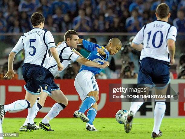 Japan's forward Takayuki Morimoto fights for the ball with Scotland captain and defender Stephgen McManus during their Kirin Challenge Cup football...