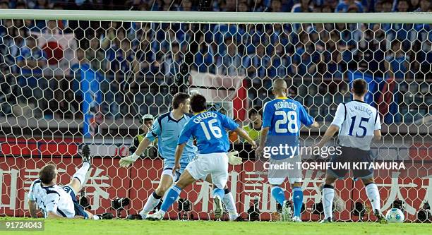 Scotland defender Christophe Berra scores an own goal during their Kirin Challenge Cup football match against Japan in Yokohama on October 10, 2009....