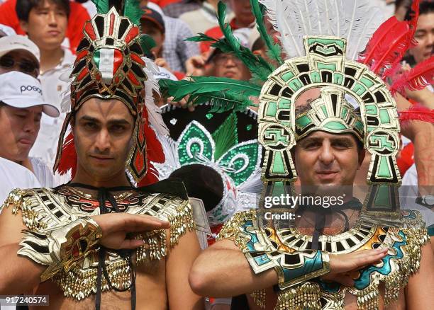 Mexico fans in Aztec costume salute during ther national anthem, 17 June 2002 at the Jeonju World Cup Stadium in Jeonju, ahead of second round...