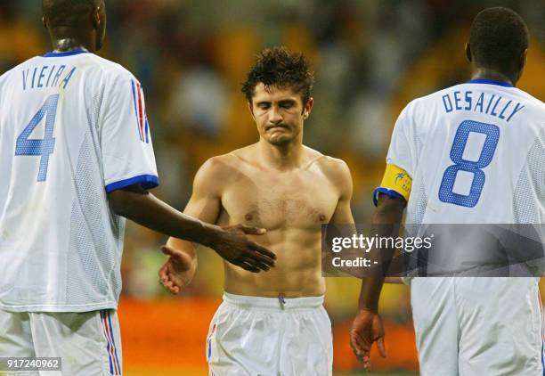 Bixente Lizarazu of France reacts as he walks off the field with Patrick Vieira and Marcel Desailly , 06 June 2002 at the Busan Asiad Main Stadium in...
