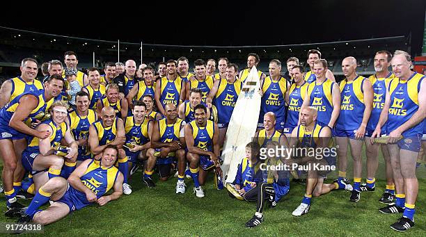 The OWLS pose with "Mainy's Board" which was presented to the winning team during the Chris Mainwaring charity AFL match at Subiaco Oval on October...