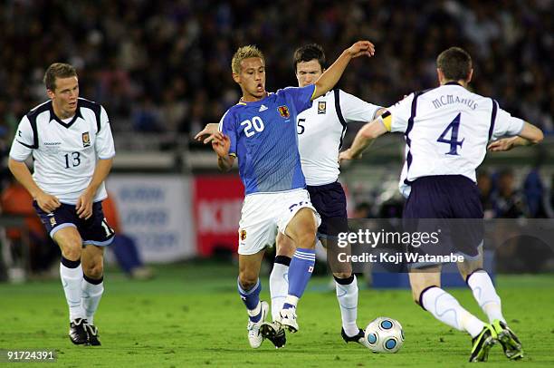 Keisuke Hondaof Japan and Stephen McManus and Gary Caldwell of Scotland compete for the ball during Kirin Challenge Cup 2009 match between Japan and...