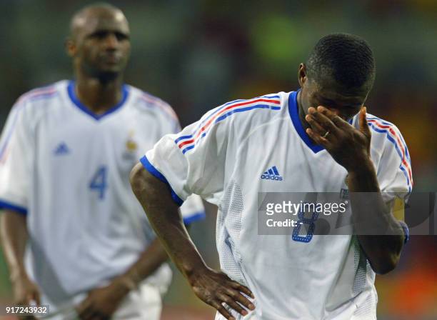 French captain Marcel Desailly reacts as Patrick Vieira follows, 06 June 2002 at the Busan Asiad Main Stadium in Busan, following the first round...