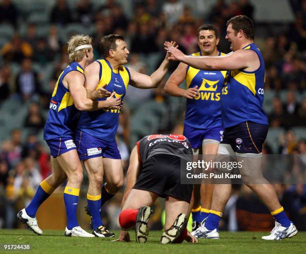 Tony Evans and Scott Cummings celebrate a goal during the Chris Mainwaring charity AFL match at Subiaco Oval on October 10, 2009 in Perth, Australia.