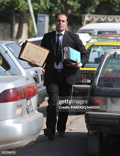 Pakistani defence lawyer Shahbaz Rajput arrives at Adiala jail for a hearing in Rawalpindi on October 10, 2009. Seven suspects accused by India of...