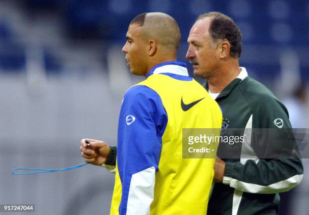 Brazilian soccer coach Luiz Felipe Scolari gives instructions to striker Ronaldo Nazario, 24 June 2002, during the training session at Saitama World...