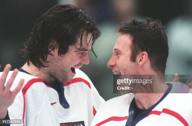 Czech players Robert Lang and Dominik Hasek celebrate during the awards ceremony after the men's Olympic hockey final at the Big Hat in Nagano 22...