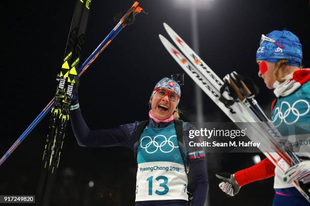 Anastasiya Kuzmina of Slovakia and Anais Bescond of France celebrate after crossing the finish line during the Women's Biathlon 10km Pursuit on day...