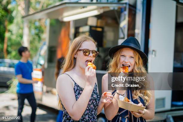 dieting with greasy but tasty junk food - food truck festival stock pictures, royalty-free photos & images