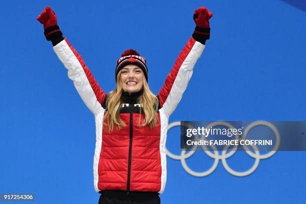 Canada's silver medallist Justine Dufour-Lapointe reacts on the podium during the medal ceremony for the women's freestyle skiing moguls at the...