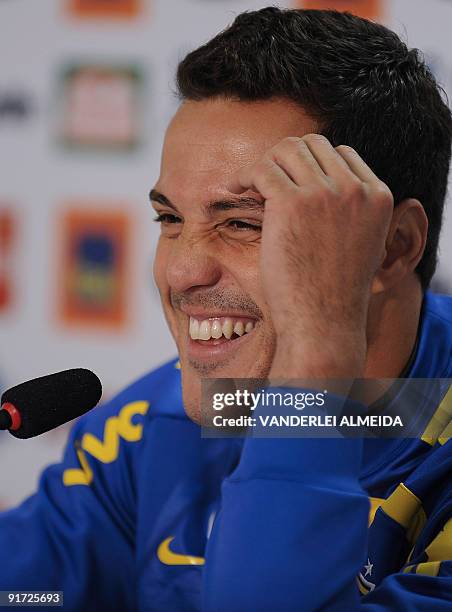 Brazilian goalkeeper Julio Cesar smiles during a press conference before a training session of the national football team on October 10 in...