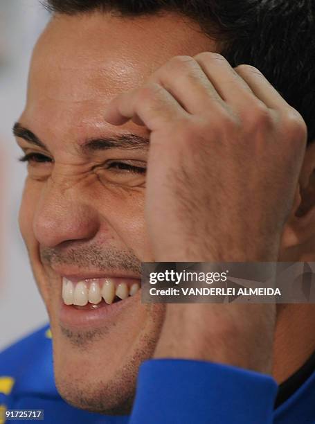 Brazilian goalkeeper Julio Cesar smiles during a press conference before a training session of the national football team on October 10 in...