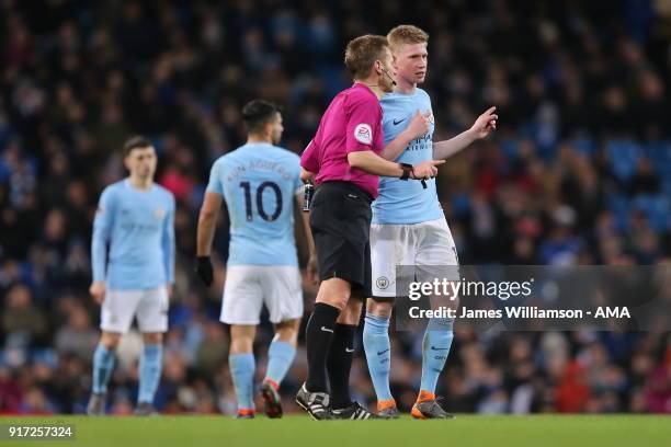 Kevin De Bruyne of Manchester City talks to match referee Michael Jones during the Premier League match between Manchester City and Leicester City at...