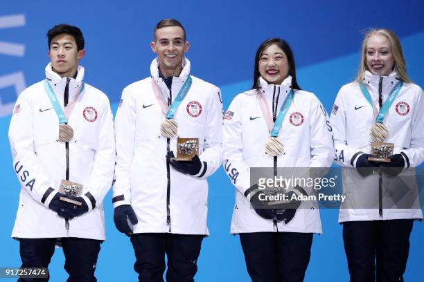 Bronze medalists Nathan Chen, Adam Rippon, Mirai Nagasu and Bradie Tennell of Team United States celebrate during the medal ceremony after the Figure...
