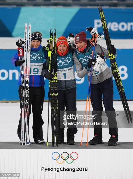 Bronze medalist Anais Bescond of France, gold medalist Laura Dahlmeier of Germany and silver medalist Anastasiya Kuzmina of Slovakia celebrate on the...