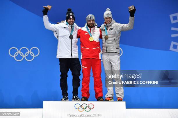 S silver medallist Chris Mazdzer, Austria's gold medallist David Gleirscher and Germany's bronze medallist Johannes Ludwig pose on the podium during...