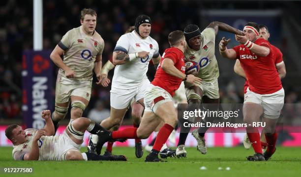 Maro Itoje of England is tackled by Elliot Dee and Wyn Jones during the NatWest Six Nations match between England and Wales at Twickenham Stadium on...