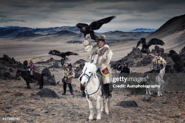 eagle hunters with the altai moutains background, mongolia - altai mountains stock-fotos und bilder