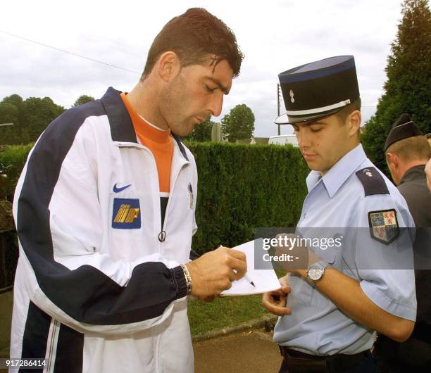 Italian goalkeeper Gianluca Pagliuca signs an autograph for a policeman after the press conference at the Senlis stadium, 08 June, two days before...