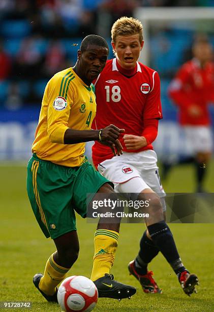 Aaron Mokeona of South Africa is challenged by Erik Huseklepp of Norway during the International friendly match between Norway and South Africa at...