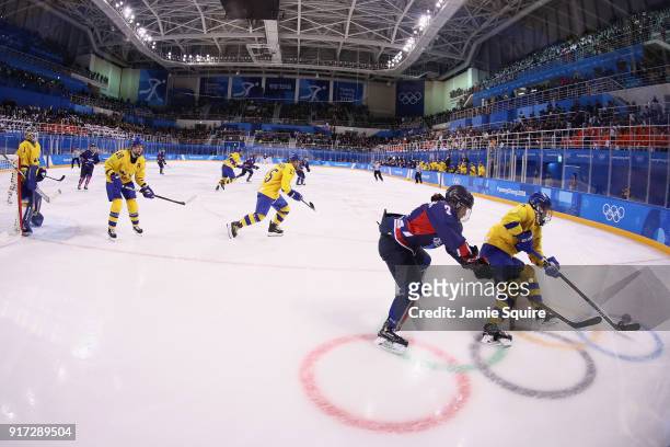 Jongah Park of Korea and Johanna Fallman of Sweden battle for the puck in the first period during the Women's Ice Hockey Preliminary Round - Group B...