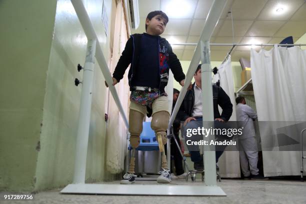 Child walks on parallel bars with prosthetic legs at a rehabilitation center in Erbil, Iraq on February 11, 2018. The rehabilitation center serves...