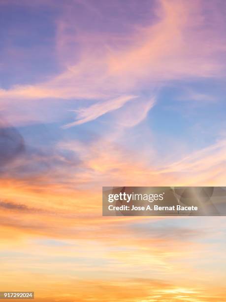 full frame of the low angle view of  sky and clouds of yellow and orange color and the  in the sunset. valencian community, spain - cielo romantico foto e immagini stock