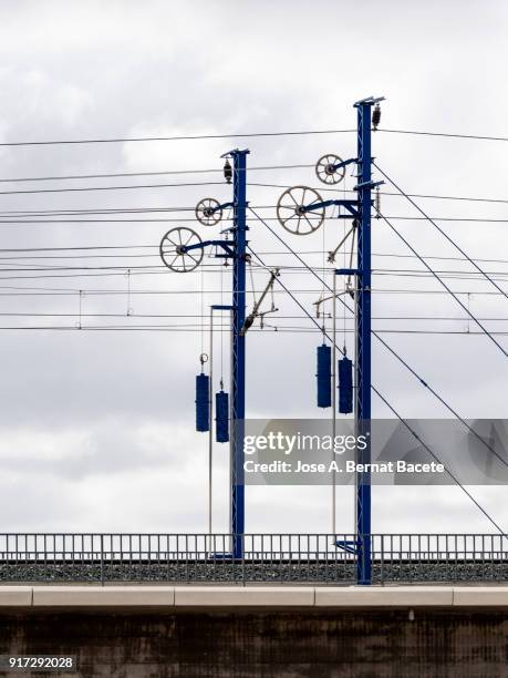 railroad track of the high-speed train ave on a bridge, with his electrical towers and	catenary. valencia, spain - metra train fotografías e imágenes de stock